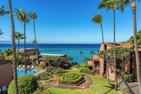 Tropical island resort property featuring oceanfront accommodations, landscaped gardens with winding pathways, and multiple pools overlooking the Pacific.