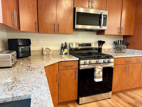Both kitchens offer granite counter tops and stainless steel appliances