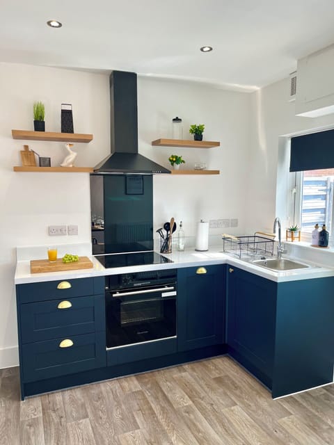 Modern kitchen fully equipped with everything, from a dishwasher to pots and pans.