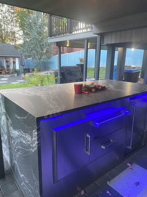Outdoor Kitchen; Lighted bar, fridge, warmer, smoker/grill, sink and storage