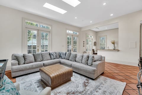 Bright, airy living room w/ plush sectional sofa — the perfect spot to unwind after a day out.
