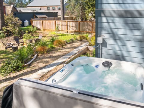 Back yard area with hot tub and outdoor firepit.