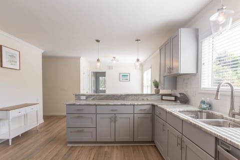 A large kitchen can be found in the heart of the home. Enjoy a gas range, oven, full size refrigerator, microwave, dishwasher, and all the basics you need for cooking. We also provide dining ware for kids and a coffee pot.