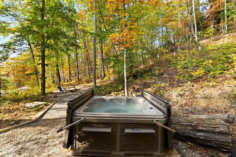 Secluded outdoor hot tub surrounded by peaceful autumn woods