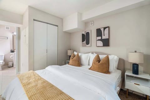 Comfortable bedroom with modern decor, soft tones, and an en-suite bathroom.