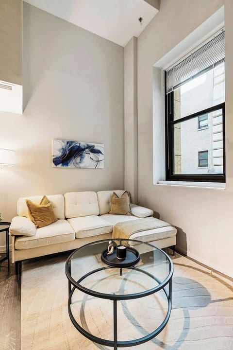 Modern loft with high ceilings, cozy seating, and chic decor in the heart of the city.