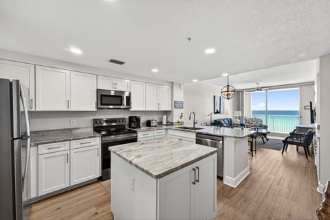 Bright, open kitchen with stunning Gulf views flowing into the living area.