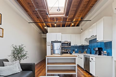 Fully stocked kitchen with an island and barstools for dining