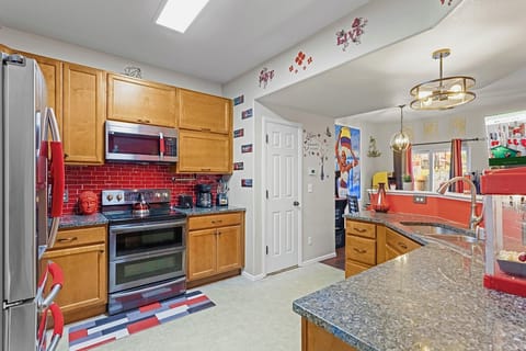 Spacious and well-equipped kitchen with modern appliances and plenty of counter space. Perfect for cooking up a feast or enjoying a quick meal.