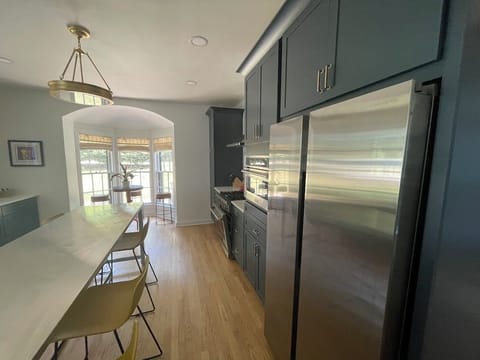 Experience versatile dining in our kitchen with a long island for meal prep and conversation, extra seating for 6, and a charming table for 4 overlooking the garden, perfect for morning coffee or afternoon tea in Saugatuck.