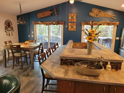 KITCHEN (SECOND FLOOR): The kitchen island with the dining area on the left.