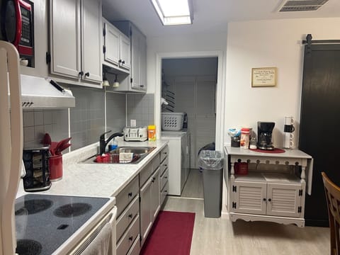 Fully stocked kitchen with spices, condiments, coffee bar, elec. stove/oven.