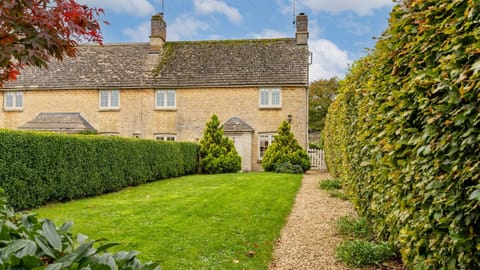 Golden Cotswold stone welcomes you at the end of the garden path