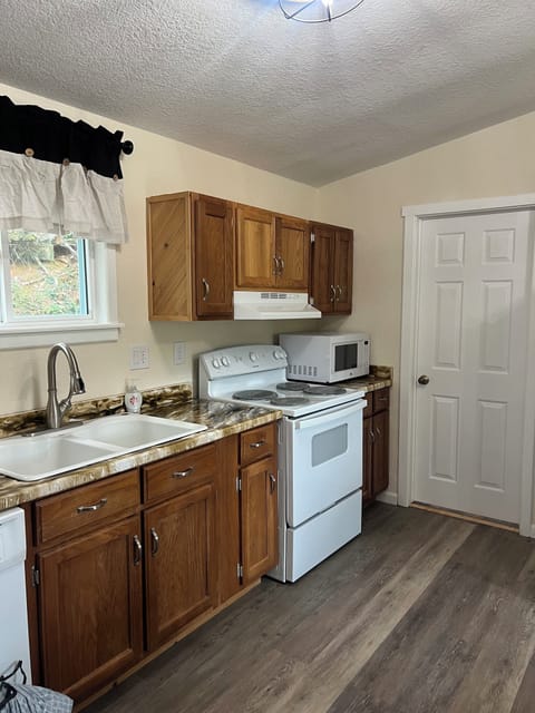 Kitchen with stove, microwave