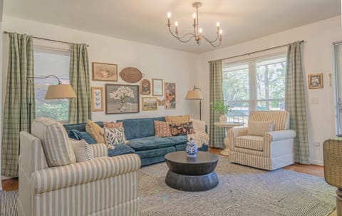Sun-drenched living room with plenty of seating.

