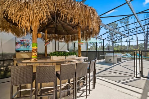 - Private tiki bar with outdoor seating and TV setup  
- Relax at luxury Orlando villa with heated pool area  
- Vacation rental with ping pong and sun loungers