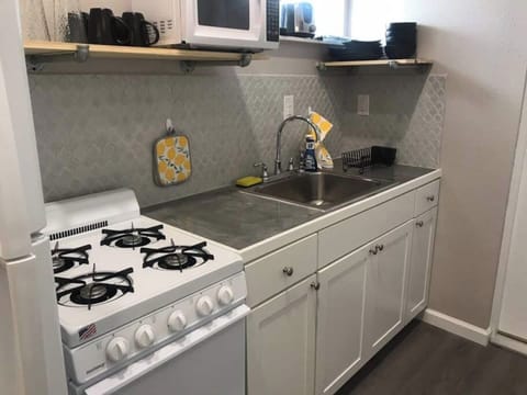 The Kitchen.  It may look small but it can handle all your cooking needs.  Stocked with pots/pans, cooking utensil and place setting for 4. 