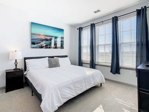 Unwind in Style: Retreat to our expansive bedroom featuring a king-size bed.