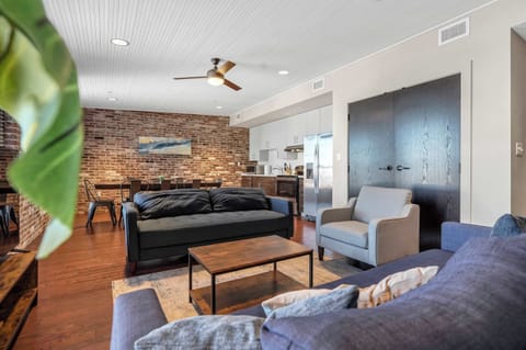 Living Room: Enjoy this comfortable living space with large windows, a flat-screen TV, and plush seating perfect for unwinding after a day of exploring.