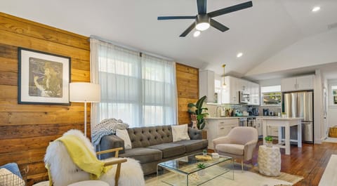 Enjoy our beautifully designed home featuring a rustic wood accent wall, chic furnishings, and an open-concept layout!