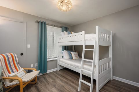 Guest bedroom suitable for guests of all ages. This twin bunk bed is suited with luxury sheets and linens. Darkening curtains and built in shelving in the closet.