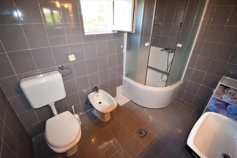 Clean bathroom with shower and amenities.