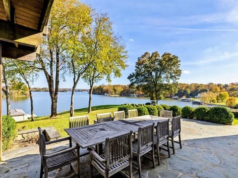 Scenic lakeside patio with ample seating, perfect for relaxing and dining with a view