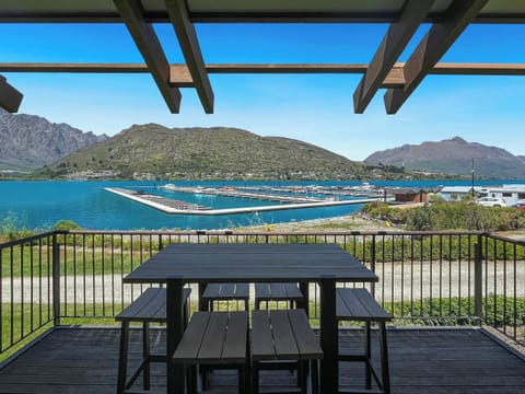 Outdoor dining set overlooking the marina and Remarkables mountains.