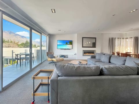 Open living area flowing onto the balcony with expansive windows and indoor outdoor connection