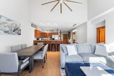 Your spacious open-plan living area flows seamlessly from the plush sofa to the dining table, perfect for relaxing after mountain adventures.