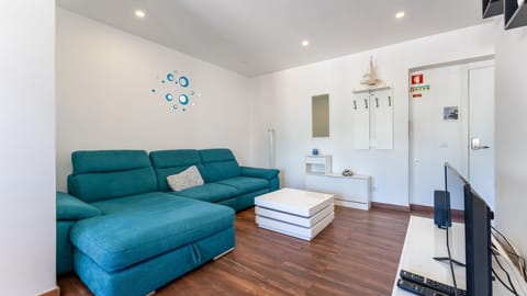 Relax in the cozy living room, complete with a plush teal sofa – ideal for unwinding after a day in the Algarve.
#CozyVibes #RelaxInStyle #SereneBlueFlat
