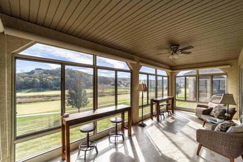 Bright sunroom with a view of the golf course