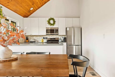 Gather for meals together at the dining table located between the kitchen and the living room.