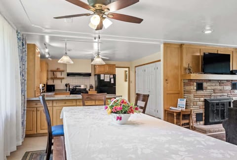 Looking towards the kitchen from the opposite end of the large dining table in White Oaks Haven.