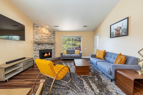 With one sofa, one loveseat and an oversized chair encircling the gas fireplace and a large flat-screen TV mounted on the wall.