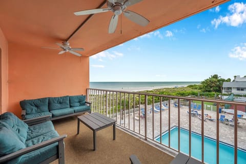 Covered balcony w/ cushioned seating overlooking the pool, ideal for slow mornings or evening unwinding.