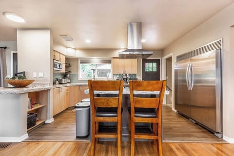 Enjoy a glass of wine with friends while making dinner for the group.