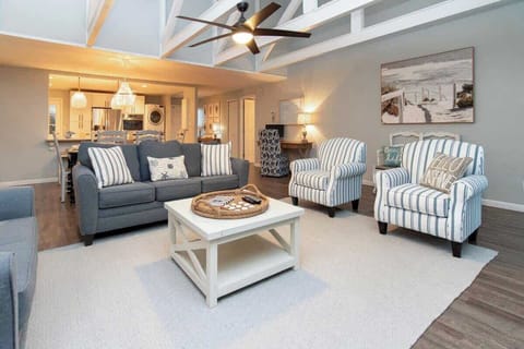 Spacious living room with striped armchairs and a cozy seating area.