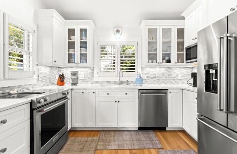 Cook your favorite meals in this bright, fully-equipped kitchen .