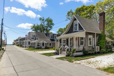 Front porch with seating. View down street to ocean beach.