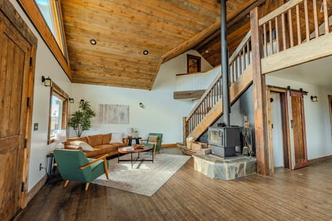 Unwind in a rustic living room with wooden beams, a cozy stone fireplace.