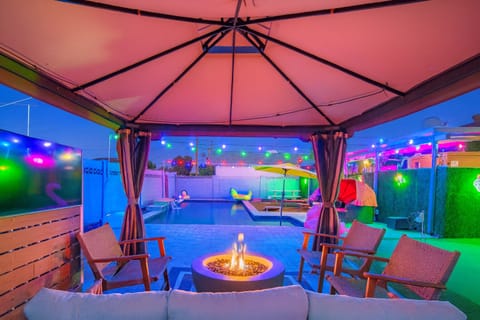Unwind in the gazebo lounge with games, grill, fireplace, seats & a 40"4K TV