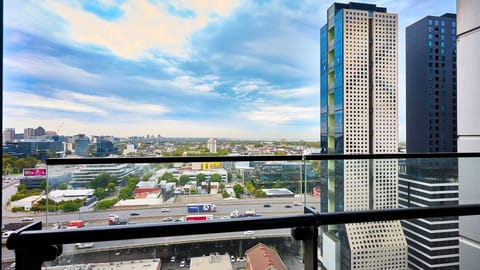 Elevated balcony views with sweeping city skyline and plenty of natural light.