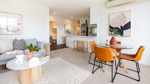 Experience seamless modern living with a light-filled lounge that transitions effortlessly into a stylish dining setup.