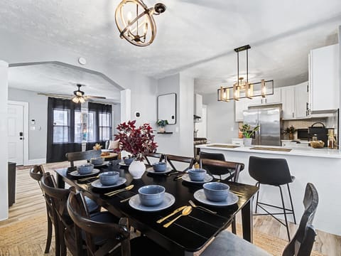 Inviting dining area w/ stylish lighting & table set for shared meals