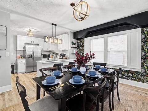 Elegant dining table set for a group beside the bright open kitchen