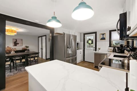 Clean lines, crisp white cabinets, and a touch of natural texture. This kitchen is a true masterpiece. Absolutely love it!