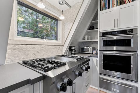 Modern kitchen with stainless steel appliances and a cozy nook for extra storage.