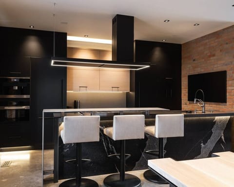 RH | Indulge in the sleek elegance of our fully equipped kitchen, featuring contemporary design and state-of-the-art amenities, perfect for preparing gourmet meals during your luxurious stay.