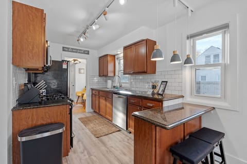 Your fully equipped kitchen features warm wood cabinets, granite counters, and modern appliances—perfect for preparing memorable meals during your stay.